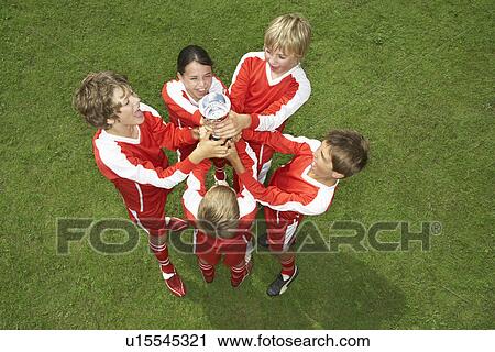 Football team holding trophy View Large Photo Image Stock Image - Football team holding trophy. Fotosearch