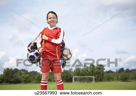 Stock Image - Footballer with bag of balls. Fotosearch