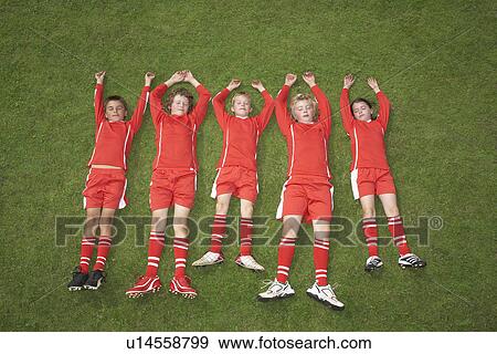 Footballers lying in a line View Large Photo Image Stock Photo - Footballers lying in a line. Fotosearch
