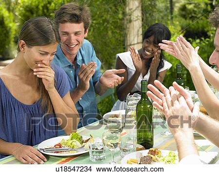 Friends having lunch in the garden View Large Photo Image Picture - Friends having lunch in the garden. Fotosearch