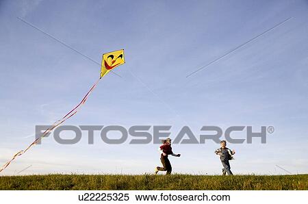 Girl and Boy fly a Kite View Large Photo Image Stock Photography - Girl and Boy fly a Kite. Fotosearch
