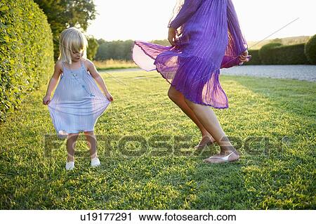 Stock Image - "Girl and woman dancing, outdoors". Fotosearch