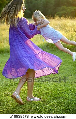 Stock Photo - "Girl and woman dancing, outdoors". Fotosearch