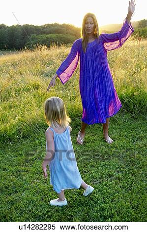 Stock Photography - "Girl and woman dancing, outdoors". Fotosearch