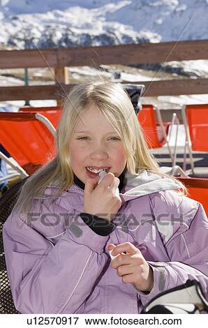 Stock Photo - Girl applying lipsalve. Fotosearch