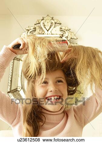 Girl brushing hair View Large Photo Image Stock Photo - Girl brushing hair. Fotosearch