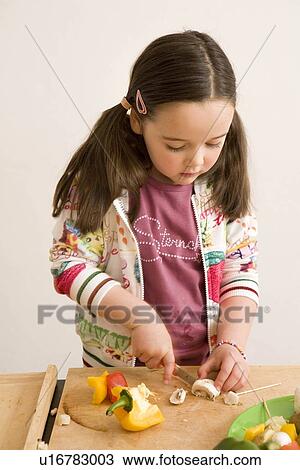Girl cutting vegetables View Large Photo Image Stock Image - Girl cutting vegetables. Fotosearch