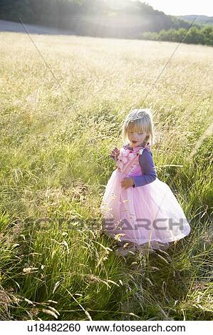 "Girl dressed as a princess, in a field" View Large Photo Image Stock Image - "Girl dressed as a princess, in a field". Fotosearch