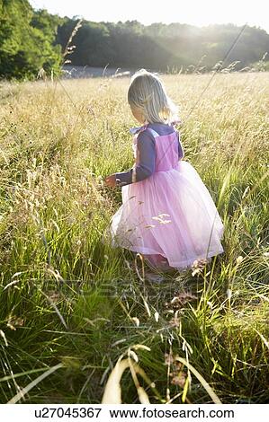 Stock Photo - "Girl dressed as a princess, in a field". Fotosearch