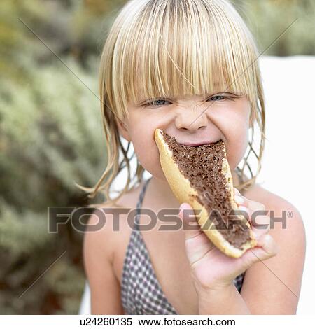 Girl eating a chocolate sandwich View Large Photo Image Stock Photography - Girl eating a chocolate sandwich. Fotosearch