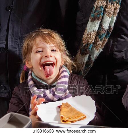 Girl eating crepe with jam View Large Photo Image Stock Image - Girl eating crepe with jam. Fotosearch