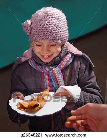 Stock Image - Girl happy with crepe. Fotosearch