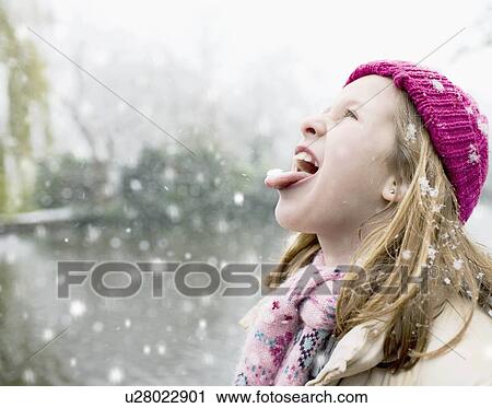 Stock Image - Girl in snowfall. Fotosearch
