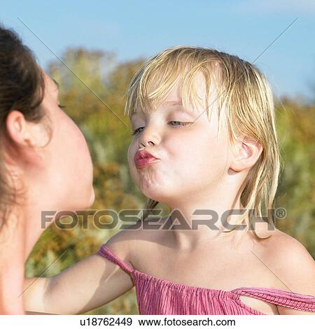 Stock Photo - Girl on her way to give a kiss. Fotosearch