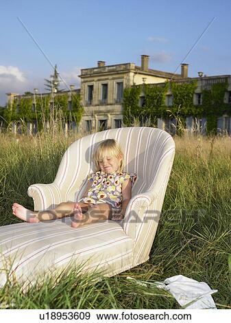 "Girl on sofa in a field, castle view" View Large Photo Image Stock Photo - "Girl on sofa in a field, castle view". Fotosearch