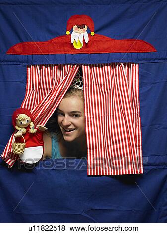 Girl playing with a puppet View Large Photo Image Stock Photo - Girl playing with a puppet. Fotosearch