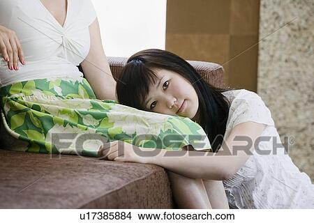 Girl resting head in mother' lap View Large Photo Image Picture - Girl resting head in mother' lap. Fotosearch