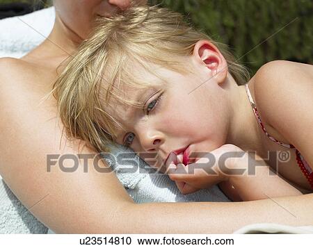 Stock Image - "Girl resting on her mother, heat". Fotosearch