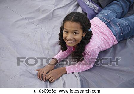 Stock Photography - Girl resting on tent. Fotosearch