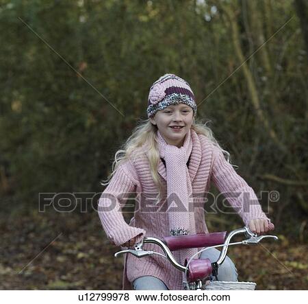 Stock Photo - Girl riding bike in countryside. Fotosearch