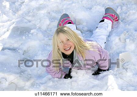 Girl rolling in snow View Large Photo Image Stock Image - Girl rolling in snow. Fotosearch