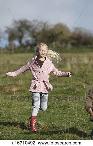 Girl running in countryside View Large Photo Image Stock Image - Girl running in countryside. Fotosearch