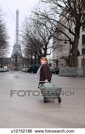 Stock Photograph - Girl running with shopping cart. Fotosearch