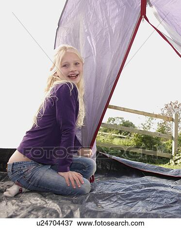 Stock Photo - Girl sitting in tent. Fotosearch