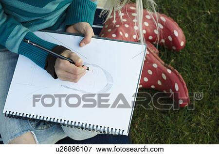 Girl sketching outside View Large Photo Image Stock Photo - Girl sketching outside. Fotosearch