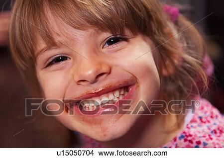 Girl smiling with chocolate around mouth View Large Photo Image Picture - Girl smiling with chocolate around mouth. Fotosearch