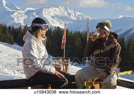 Girl snowboarders having apres beers View Large Photo Image Stock Photo - Girl snowboarders having apres beers. Fotosearch