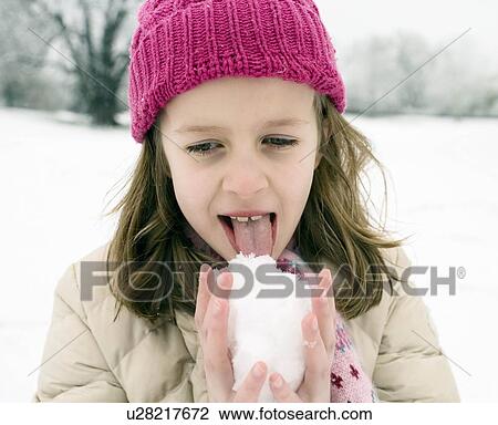 Girl tasting snow ball View Large Photo Image Stock Image - Girl tasting snow ball. Fotosearch