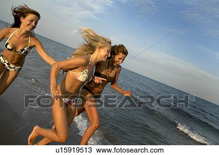 Girl teenagers running on the beach View Large Photo Image Stock Image - Girl teenagers running on the beach. Fotosearch