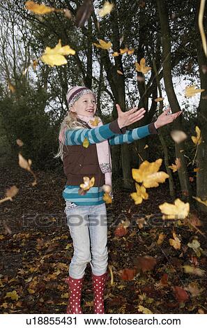 Girl throwing autumn leaves View Large Photo Image Stock Image - Girl throwing autumn leaves. Fotosearch