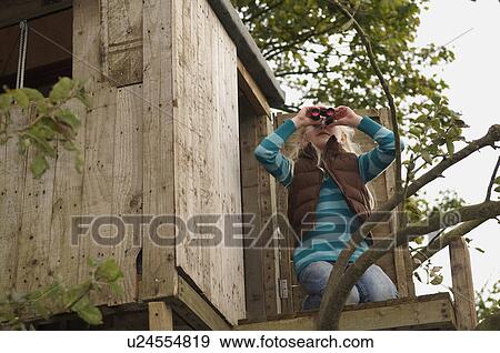 Girl with binoculars in treehouse View Large Photo Image Stock Photo - Girl with binoculars in treehouse. Fotosearch