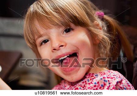 Girl with pink candy on tongue View Large Photo Image Stock Image - Girl with pink candy on tongue. Fotosearch
