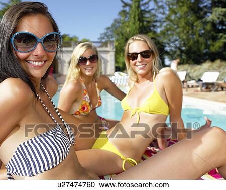 Girlfriends by the pool View Large Photo Image Stock Image - Girlfriends by the pool. Fotosearch