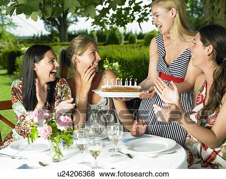 Stock Photo - Girlfriends celebrating a birthday. Fotosearch
