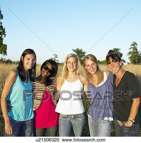 "Girlfriends in a field, smiling" View Large Photo Image Stock Image - "Girlfriends in a field, smiling". Fotosearch