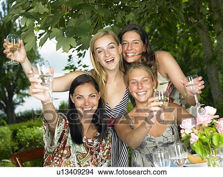 Picture - Girlfriends toasting their glasses. Fotosearch