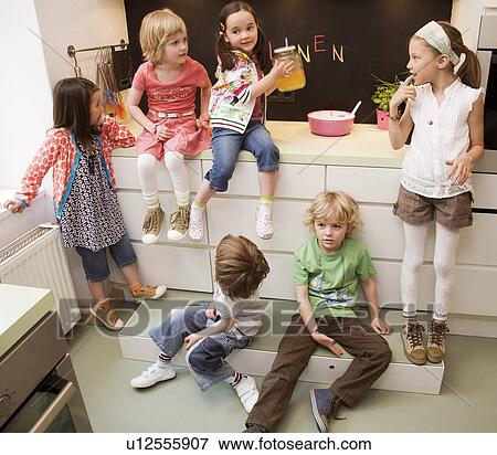 Stock Photo - Girls and boys cooking. Fotosearch
