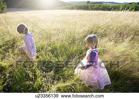 Stock Photo - "Girls dressed as princesses, in a field". Fotosearch