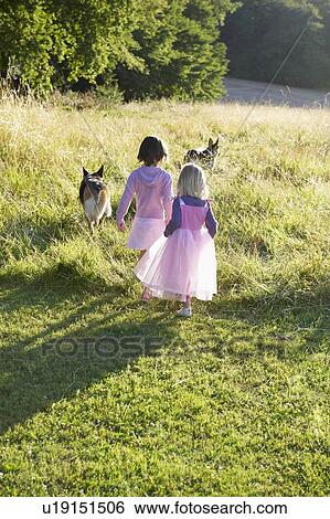Stock Photograph - "Girls dressed as princesses, with dogs". Fotosearch