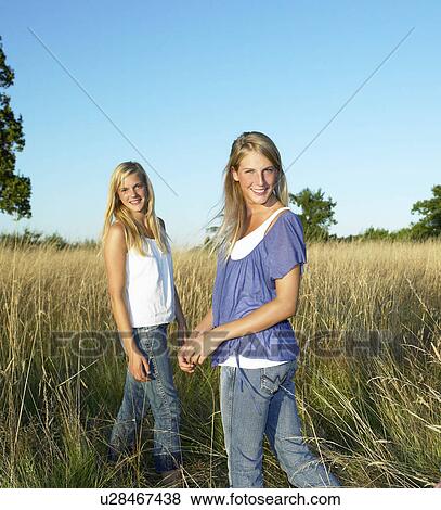 "Girls in a field, smiling" View Large Photo Image Stock Photo - "Girls in a field, smiling". Fotosearch