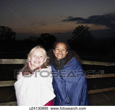 Girls in sleeping bags at dusk View Large Photo Image Stock Photography - Girls in sleeping bags at dusk. Fotosearch