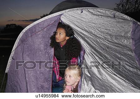 Picture - Girls in tent at dusk. Fotosearch