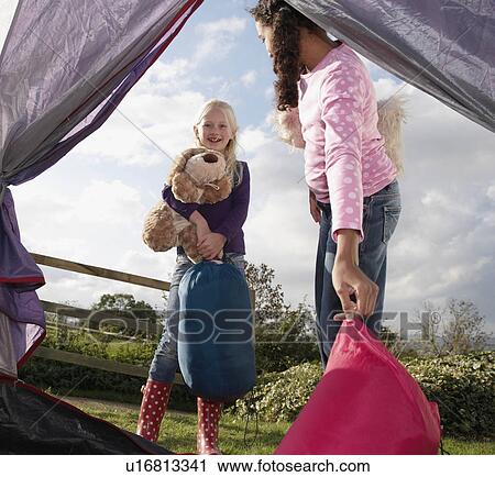 Girls putting sleeping bags in tent View Large Photo Image Stock Image - Girls putting sleeping bags in tent. Fotosearch