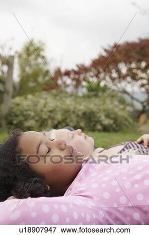 Stock Photo - Girls resting on tent. Fotosearch
