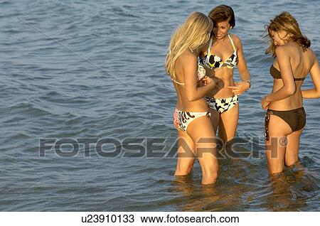 Stock Image - Girls teenagers playing in the sea. Fotosearch