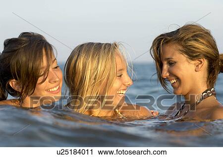 Girls teenagers playing in the sea View Large Photo Image Stock Image - Girls teenagers playing in the sea. Fotosearch